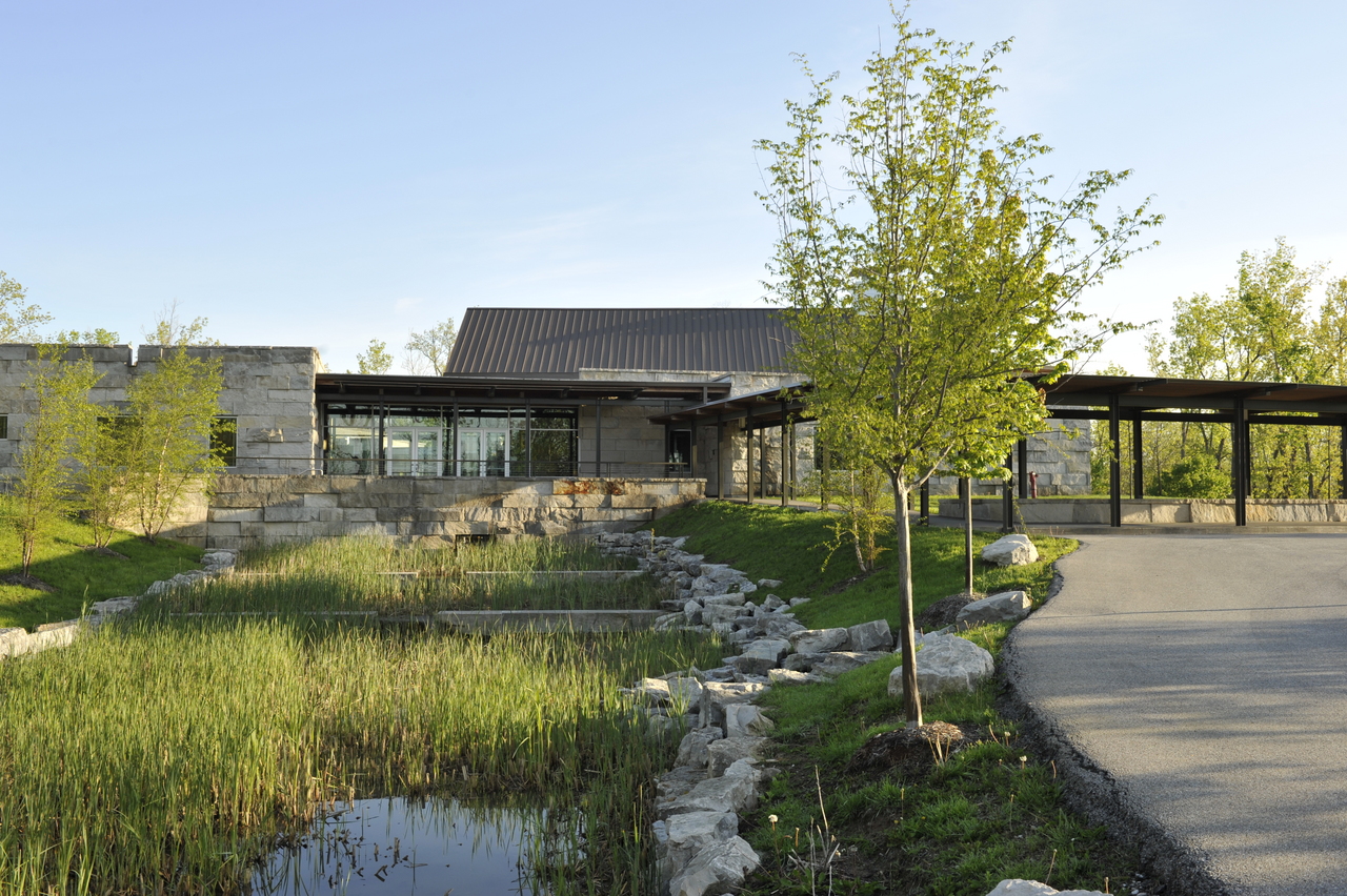Side view of Prindle building exterior with grass, trees and ponds in the forefront.