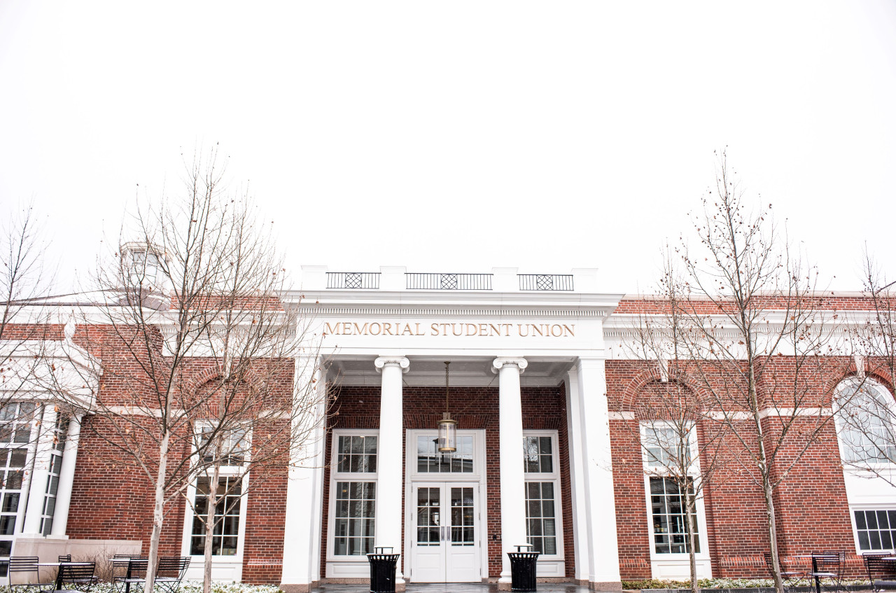 Front entrance of the Union Building, a brick building with white columns, in winter.