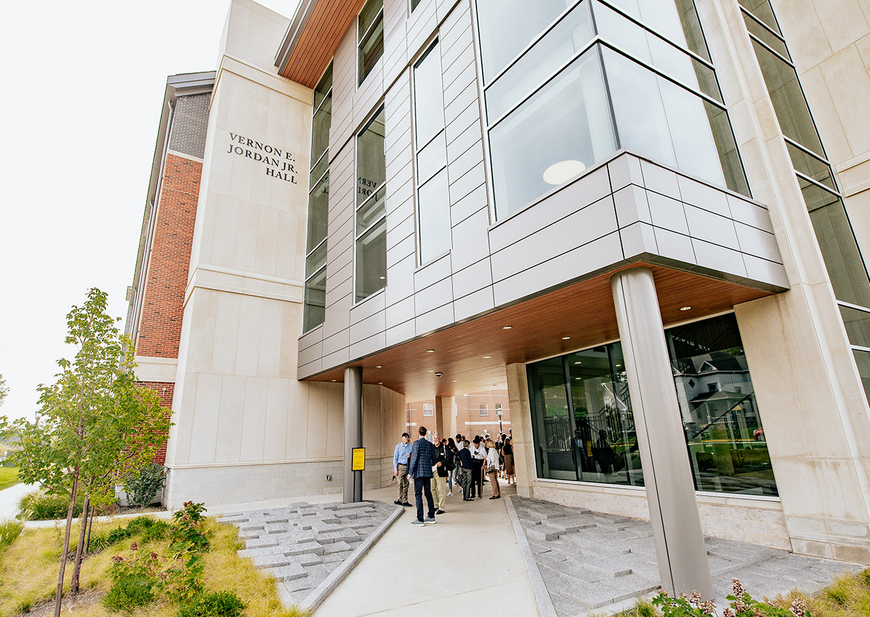 Exterior of Jordan Hall with a group of people walking through the entrance.