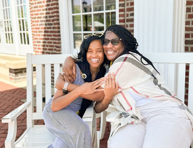 Two alumni hugging