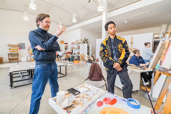 Professor and student viewing an art project