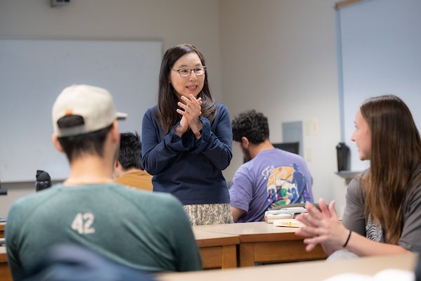 Professor talking with students during class
