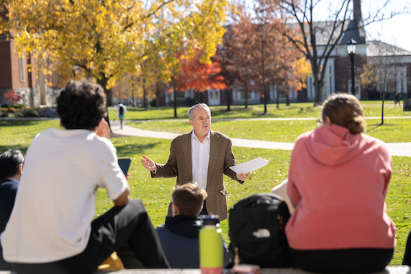Faculty member talking with students during an outside class