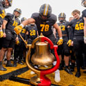 Football players ringing the Monon Bell