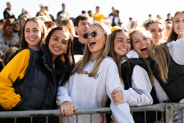 Students posing and smiling at an event