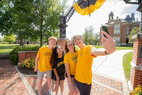 Students taking a selfie under the Anderson Street Arch