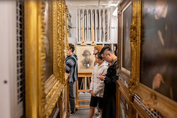 Students looking through an art collection